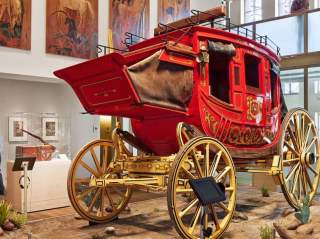 Red covered wagon inside musem exhibit
