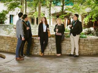 Group of meeting professionals gathering in front of grotto at Henry B.Gonzalez Convention Center