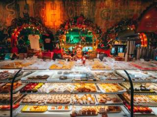 Woman standing behind bakery stand