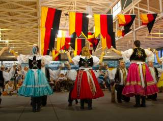 Group of people in German attire dancing.