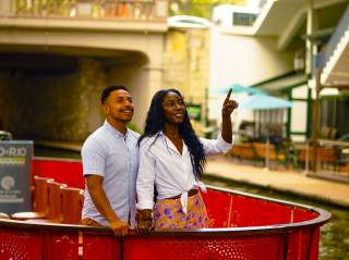 Couple on a Go Rio Barge on the River Walk smiling