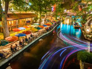 River Walk pathway lit with colorful umbrellas