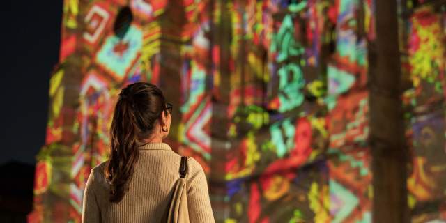 Woman looking at San Antonio | The Saga show at San Fernando Cathedral.