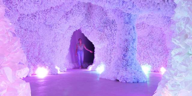 Woman in colorful cave of art