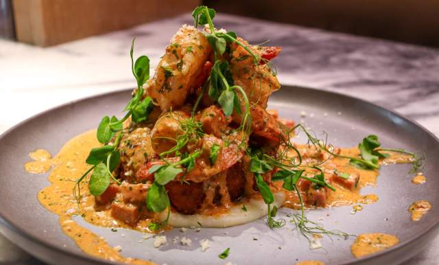 Plated dish with creamy toppings on top of it.