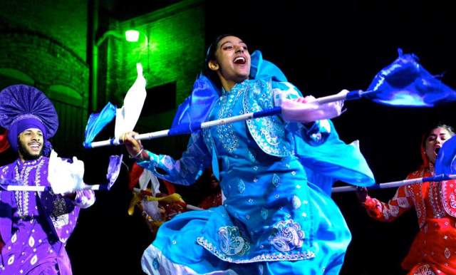 Costumed performers at DiwaliSA with multicolored performance pieces.