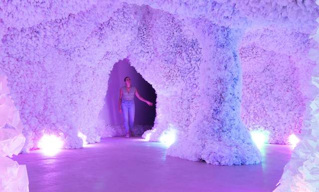 Woman in colorful cave of art