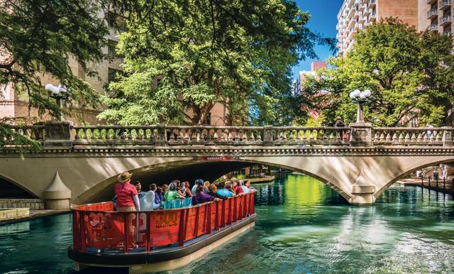 Boat passing under bridge