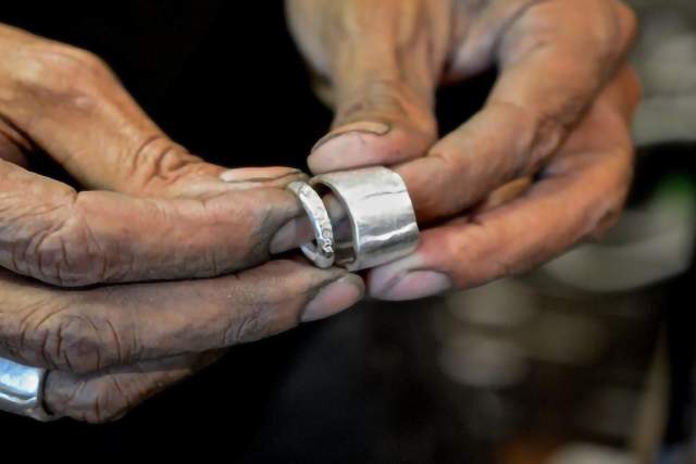 man holding silver ring