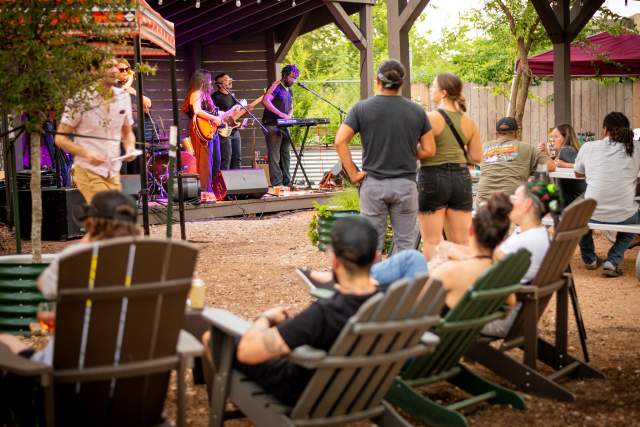 guests at an outside patio listening to live music
