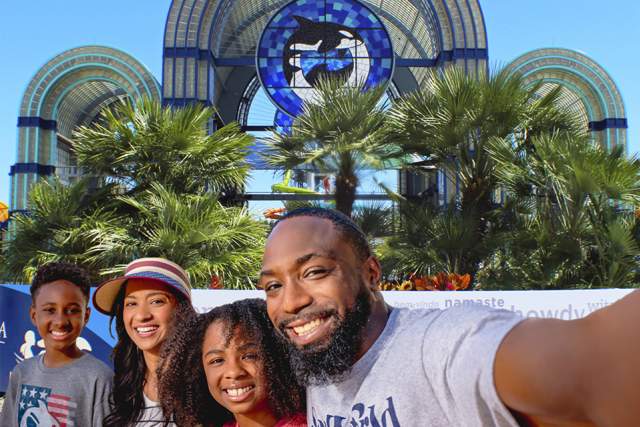 Family taking selfie in front of SeaWorld San Antonio arches