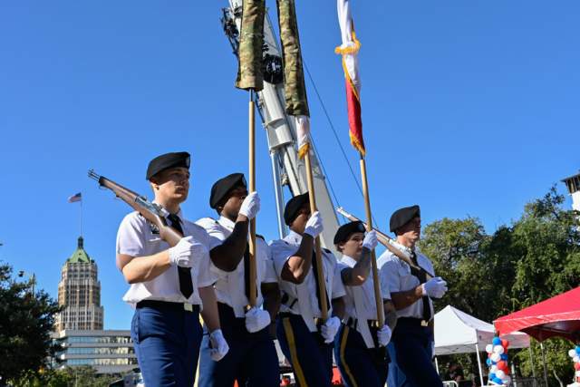 Men in uniform holding flags