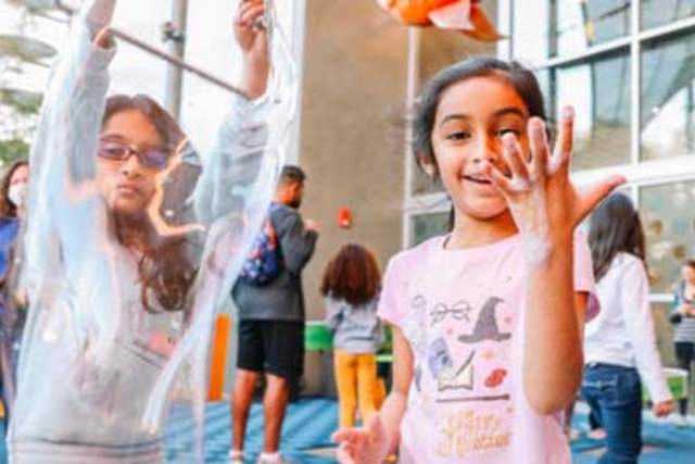 Two girls playing with bubbles