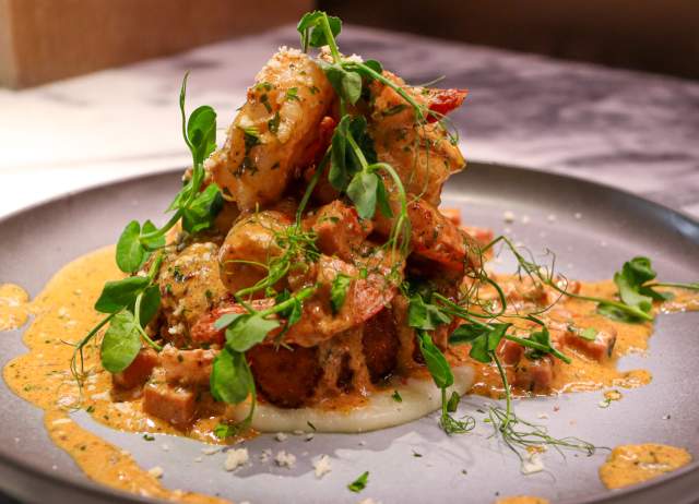 Plated dish with creamy toppings on top of it.