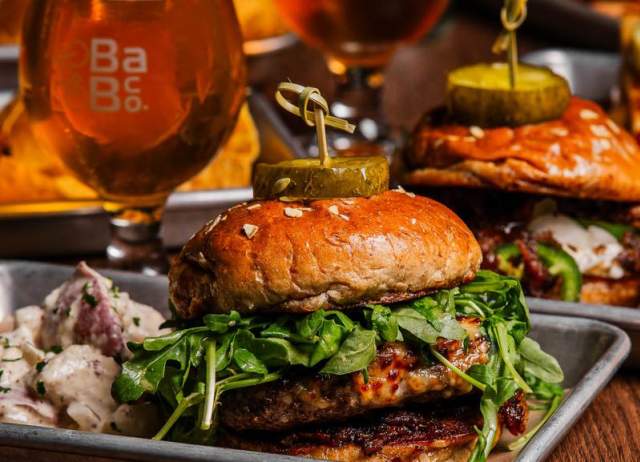 A juicy hamburger with beer in a glass