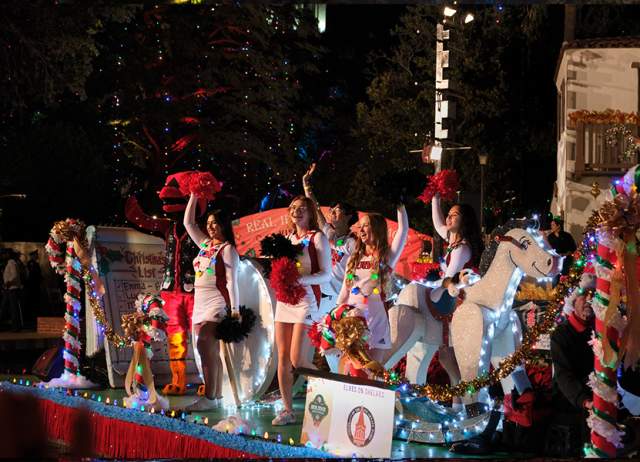 Group of people waving on holiday themed float