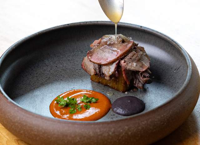 Spoon drizzling glaze over meal.