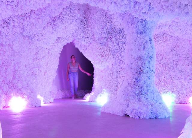 Woman in colorful cave of art