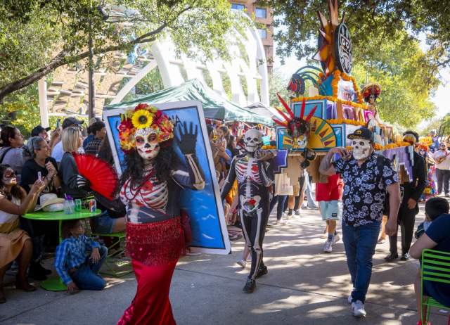 Procession with people dressed in sugar skull attire