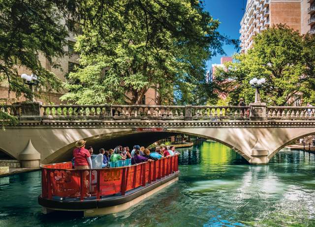 Boat passing under bridge