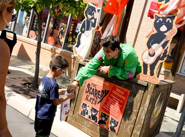 Costumed character handing out candy at Six Flags Fiesta Texas' Tricks and Treats.