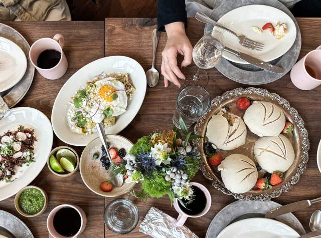food spread out on a table with brunch food