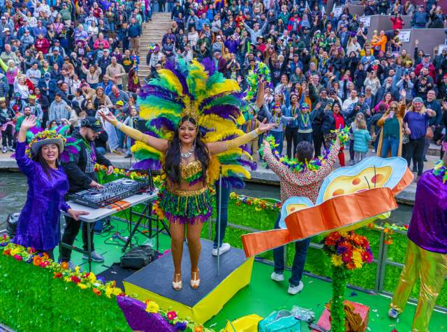 Woman on parade float at San Antonio River Walk Mardi Gras River Parade
