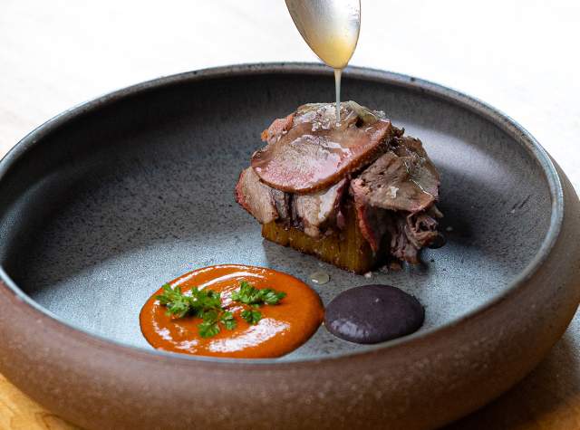 Spoon drizzling glaze over meal.
