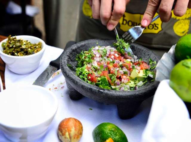 Guacamole being made in a molcajete