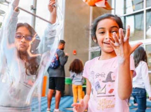 Two girls playing with bubbles