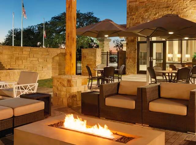 Luxury outdoor hotel patio with fireplace