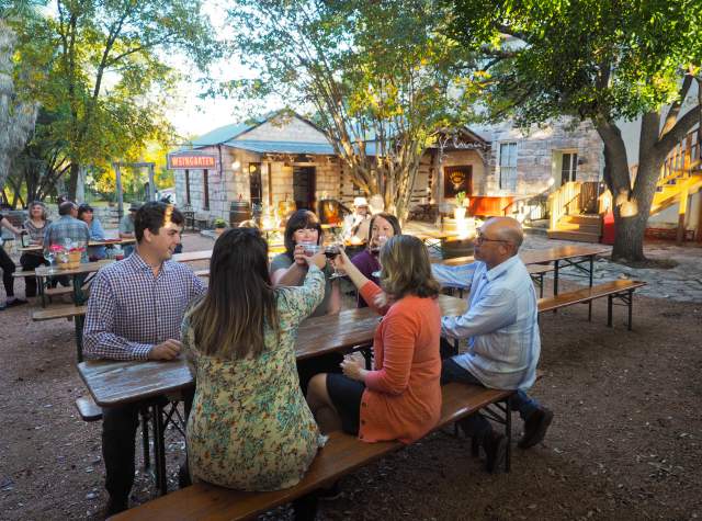 Group of people sitting at table making a toast