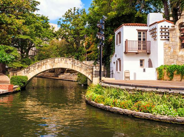 Water flowing under bridge at River Walk in front of Arneson River Theatre.