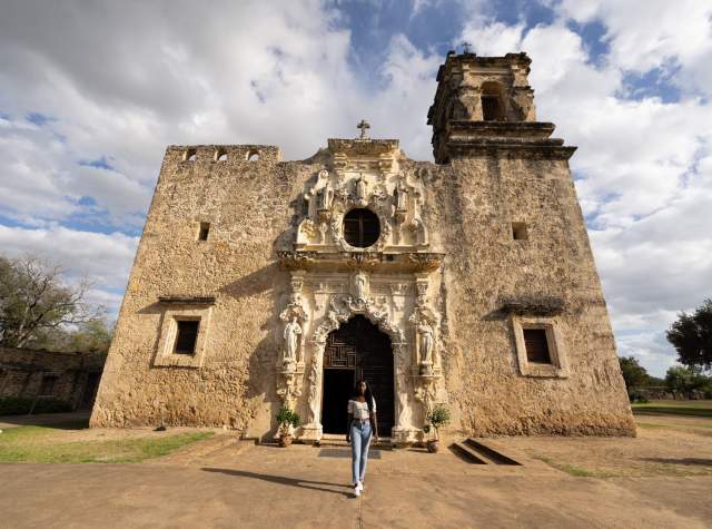 Woman standing in front of San Antonio Mission