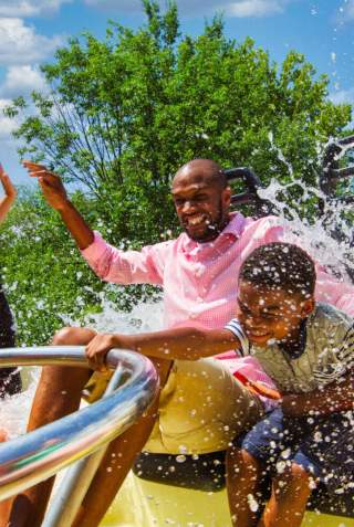 Family on circular ride being splashed
