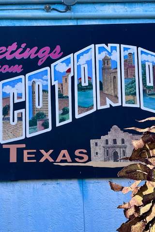 Mural of postcard that reads "Greetings from Tacotonio, Texas"