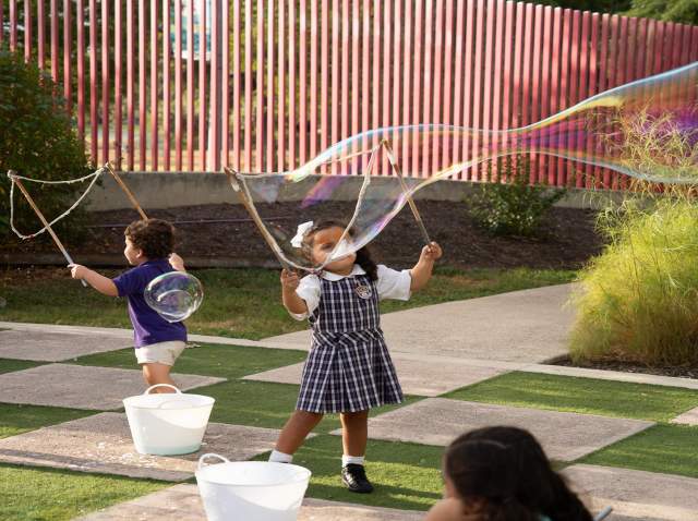 kids blowing bubbles outside