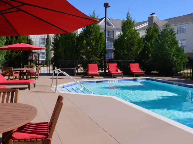 Hotel pool with red lounge furniture