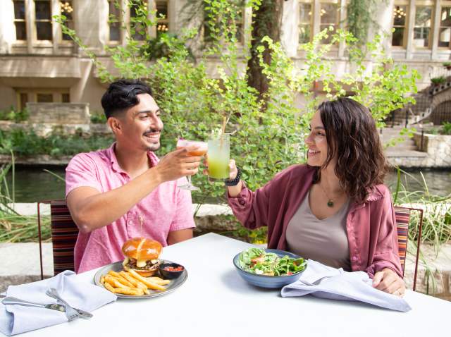 Couple cheers and dines on the San Antonio River Walk