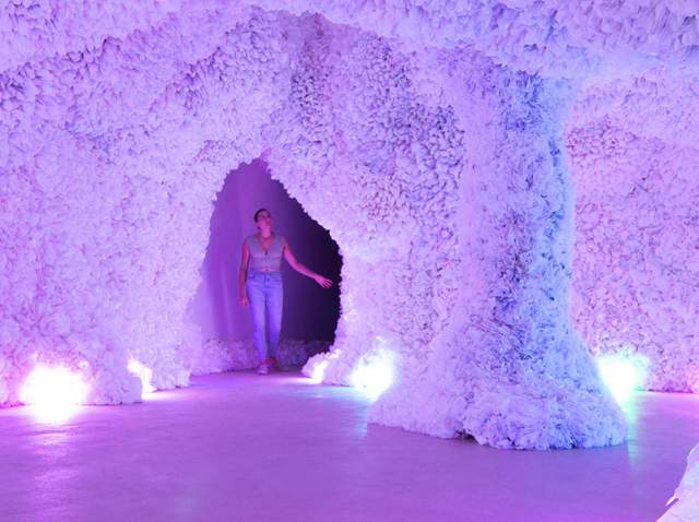 Woman in colorful cave of art