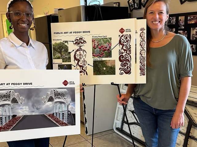 Ismani Sun posing with her artwork