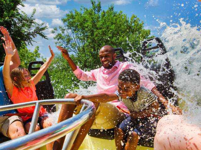 Family on circular ride being splashed