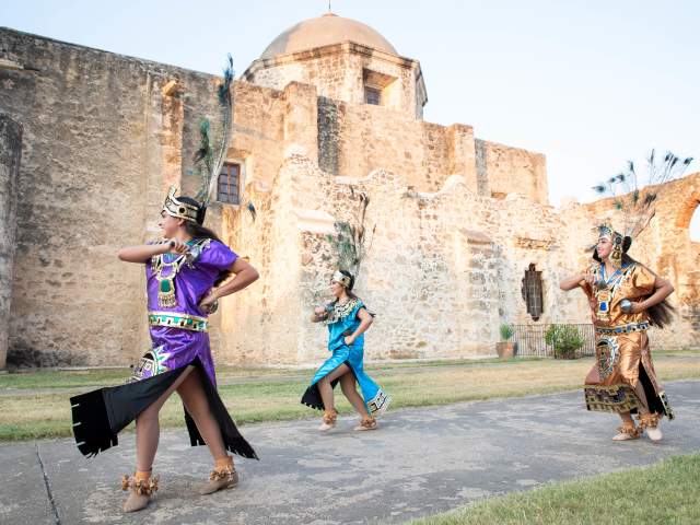 Performer smiling at San Antonio Missions National Historical Park.