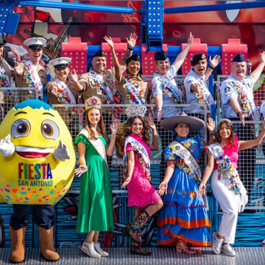 Group of people smiling and posing with costumed cascarone.
