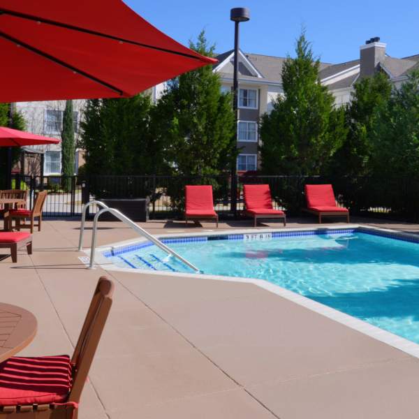 Hotel pool with red lounge furniture