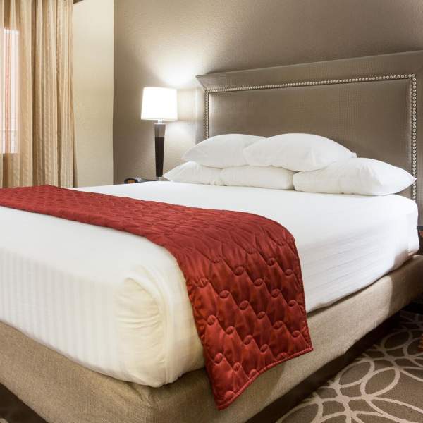 Hotel bed with nightstand and lamp