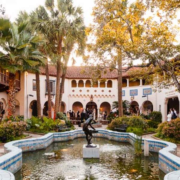 Exterior view of McNay Art Museum with outdoor sculpture and fountain.