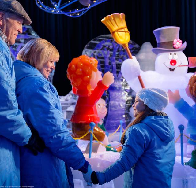 Families looking at Frosty the Snowman exhibit.