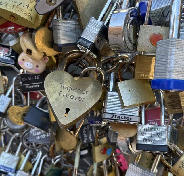 Padlocks with initials engraved and written on at San Antonio Love Lock Bridge.