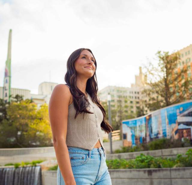 Woman admiring outdoors in front of mural at San Pedro Culture Creek.